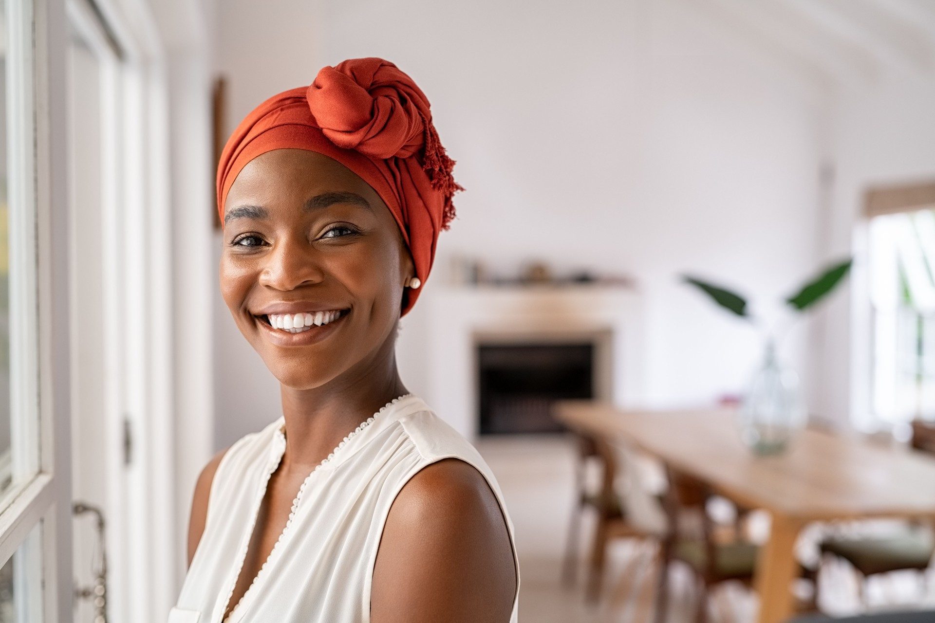 Smiling black mid adult woman wearing traditional turban